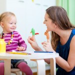 Mother and daughter playing with finger toys