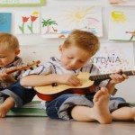 Boys playing with guitars --- Image by © Edith Held/Corbis
